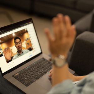 Joon waving at class on computer